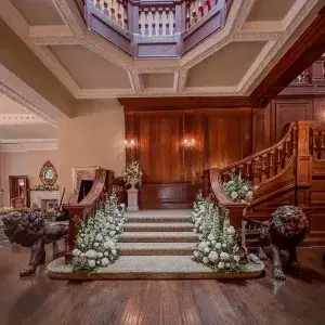 Bourton Hall grand staircase with white flower arrangements