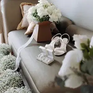 White roses and gypsophilia wedding bouquets on a chaise lounge